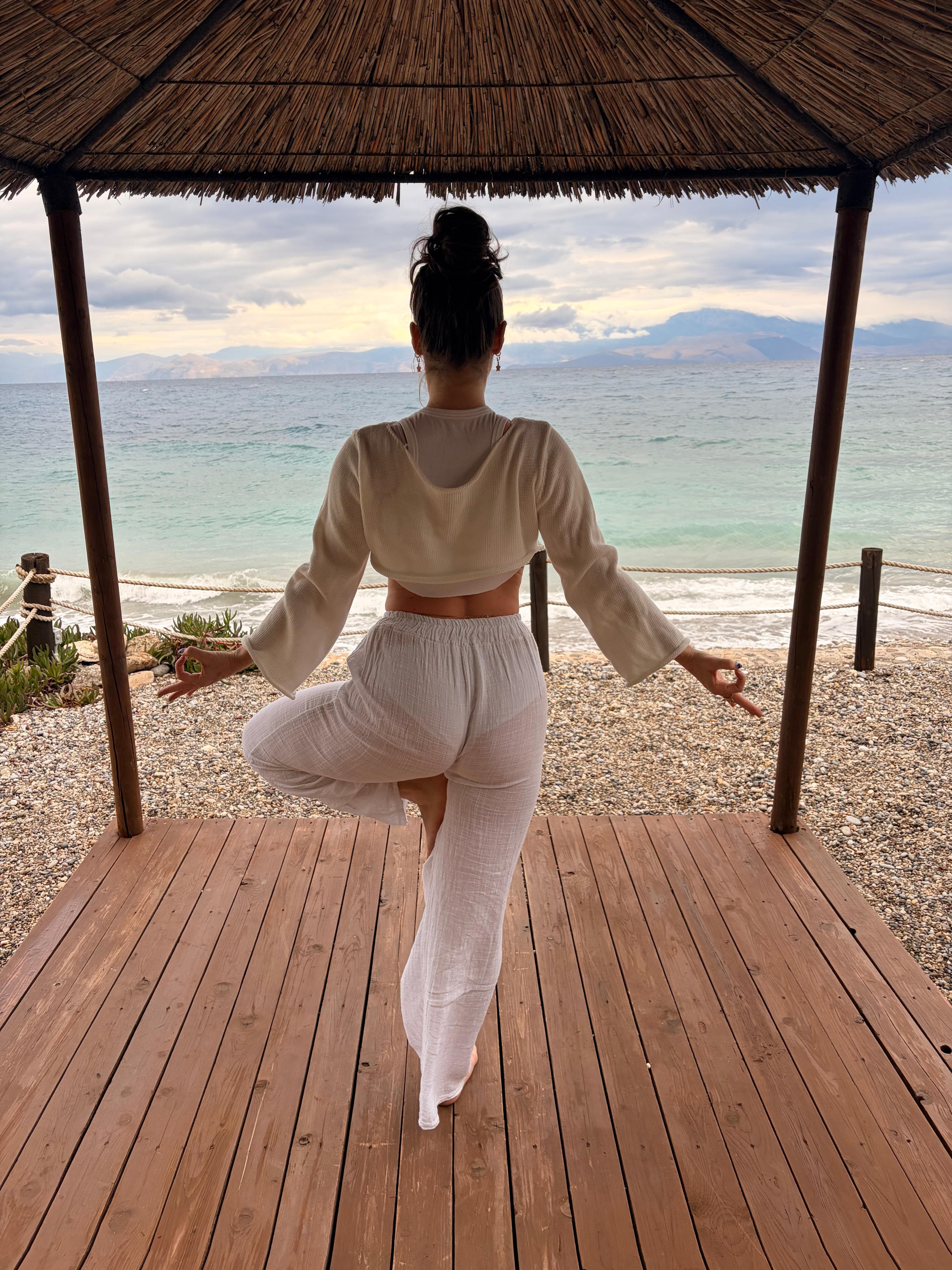 Aisling practising yoga beside the sea